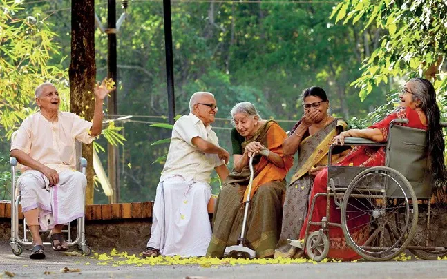 A happy senior citizen enjoying the warmth and comfort of the well-furnished living area at Ashirwad Elders Home, symbolizing care and relaxation